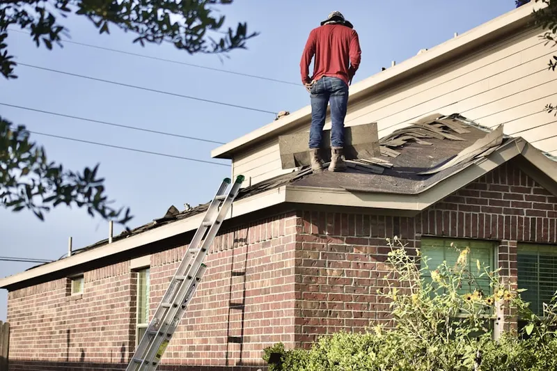 Professional roofer working on a residential roof in Keeneyville